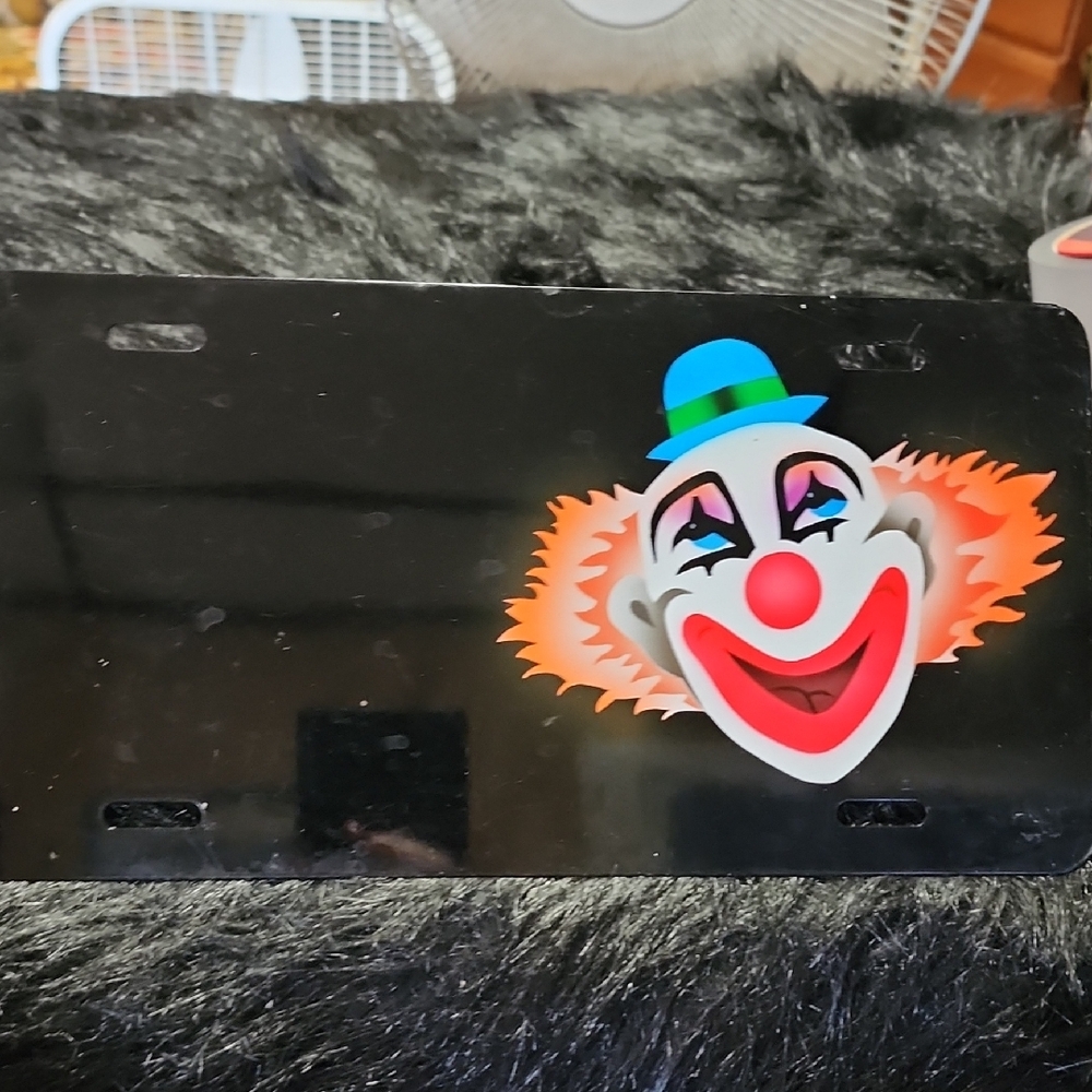 Black License Plate with Clown Design. Metal.